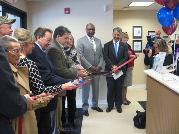 St. Clare, town officials and distinguished guests cut the red ribbon opening the Sussex Community Urgent Care Center.
