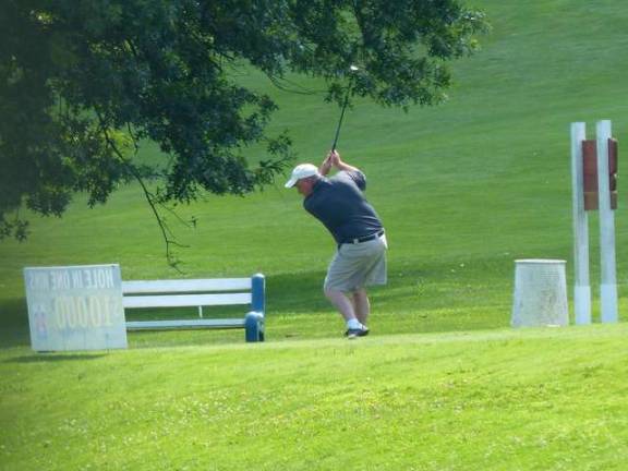 A golfer swings during the outing.