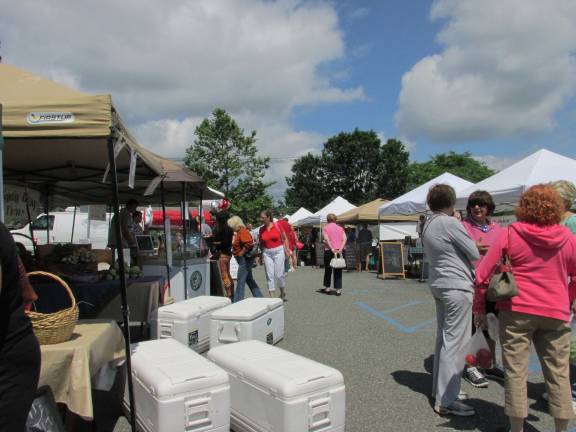 Local folks, farms and food meld together at Farmers market Locals browse the market.