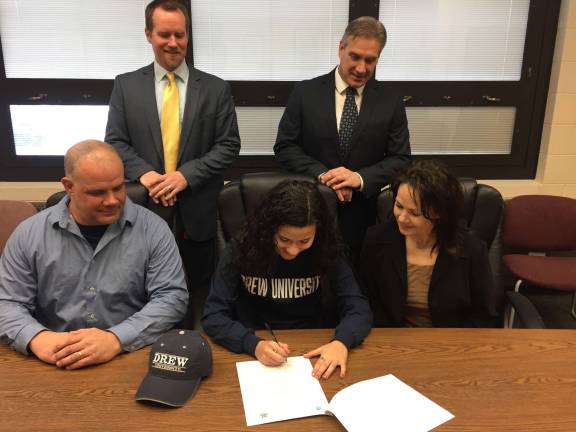 Ela Christensen, center, will continue her soccer career at Drew University. Seated with Ela are parents Gary and Lissett, and standing from left to right are Principal Jon Tallamy and Athletic Director Todd Van Orden.