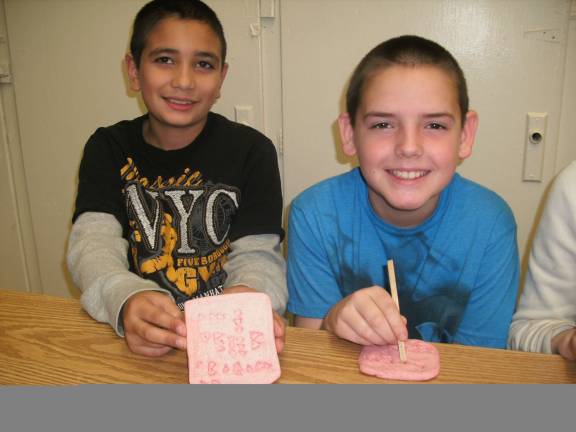 Phoenix Nunes and Devin Wylie are shown learning cuneiform.