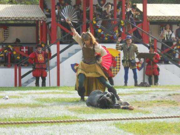 Locals perform at the Renaissance Faire Kelly Kilcoyne of Warwick plays Jenny Wren of Robin Hood's Merry Band. She is shown defeating an opponent at the live Chess Match.