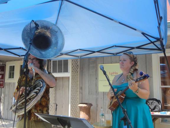 Photo by Scott Baker Lake WallKill native Debbie Davis is playing the ukelele with her New Orleans native husband Matt Perrine on the Sousaphone during the Lafayette BBQ and Blues festival in 2013.