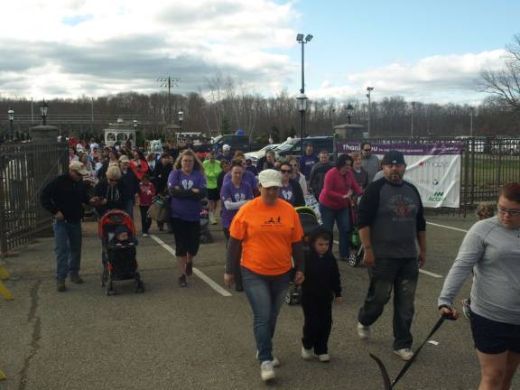 Many of the walkers hugged themselves to stay warm at 9 a.m. Sunday.