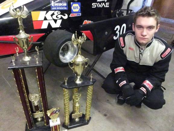 A need for speed Smith with trophies he has won.