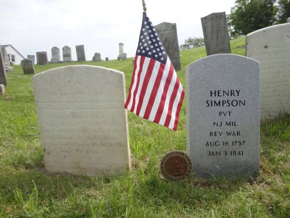 The original tombstone of Revolutionary War veteran Henry Simpson stands next to the brand new stone supplied by the US Department of Veteran Affairs after a DAR request. Photo by Scott Baker
