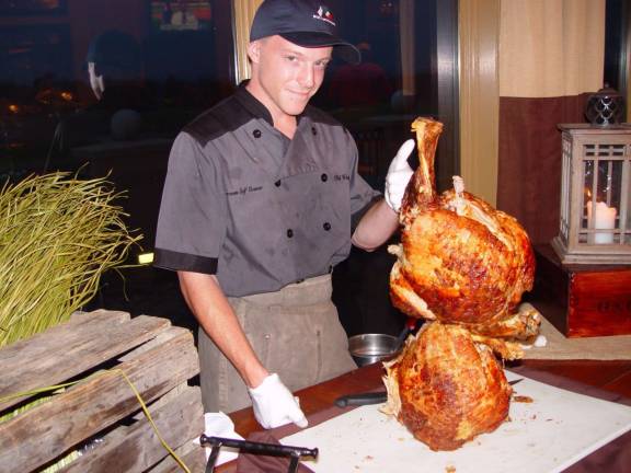 Crystal Springs Food &amp; Beverage Staffer shows the large roast pork to be served to the golfers.
