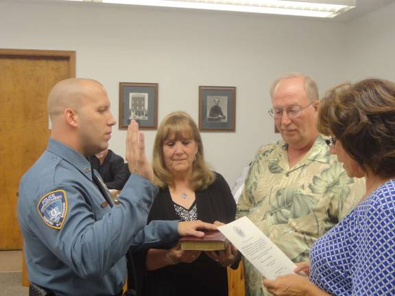Hamburg swears in two new police officers Patrolman Jeffrey Sokolowski is sworn in as a Hamburg police officer by Doreen Schott as his parents, Candice and Jeffrey Sr., hold the Bible on Monday. Photo by Scott Baker