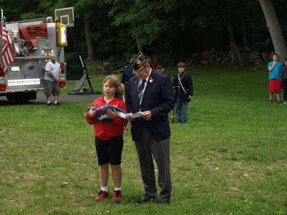 Retiring of the flag Logan Murphy of Hardyston, and Legion member John Kopcso of Franklin with the first flag to be burned.
