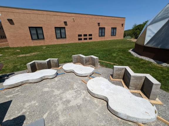 Poured concrete bench bases and tops cure before assembly.