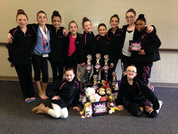 Dance Expression Performers earn high honors Dance Expression dancers are shown with their trophies.