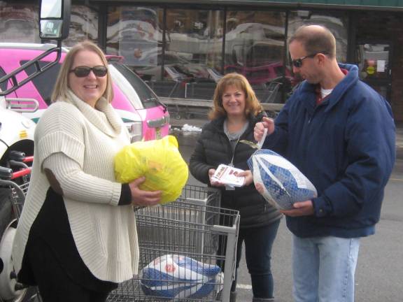PHOTOS BY JANET REDYKEFrom left: Director of Social Services Joan Bruseo, Social Services employee Sharon Babcock and Sussex County Transit driver Jeff Staple receive food donations for the county pantry to be distributed throughout Sussex County.