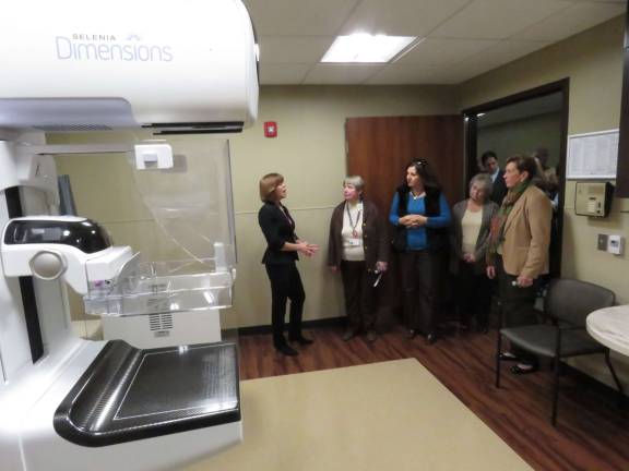Linda Lakomy, breast imaging navigator, greets visitors touring the new center, and educates them about the new 3-D tomography unit.