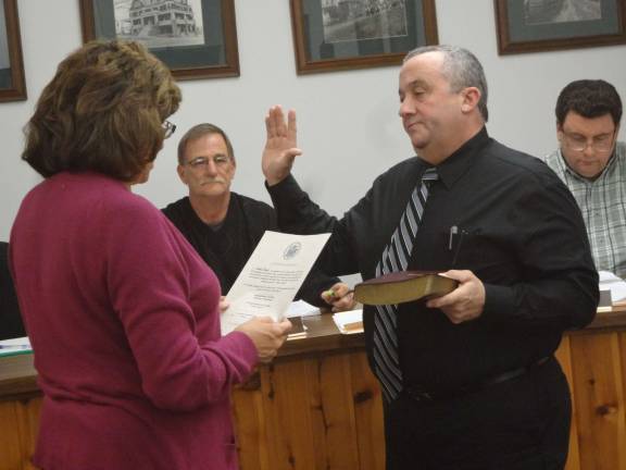 Photo by Scott Baker Russell Law is sworn into his council seat to fill Chris Kelly's sweet until the someone is elected in November to finish the term ending Dec. 31, 2016.