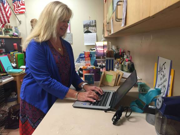 Hilltop Art Teacher SuzAnne Pacala uses her new Chromebook to prepare for the start of the 2016-17 school year.