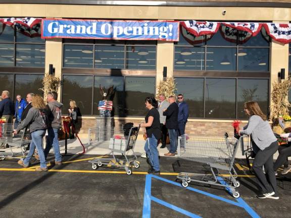 Shoppers line up to enter the new store. (Photo by Kathy Shwiff)