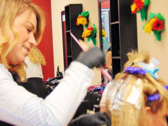 Veteran hairdresser opens salon Hairdresser Randi Tiger highlights a clients hair.
