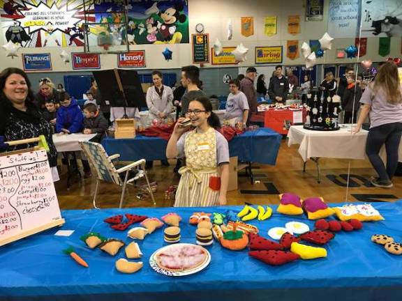 Fourth-grade business owner Mary Patti selling her handmade food stuffies.