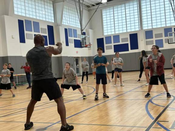 YMCA helps students get fit Instructor Ron Fisher leads the group in a fitness class.