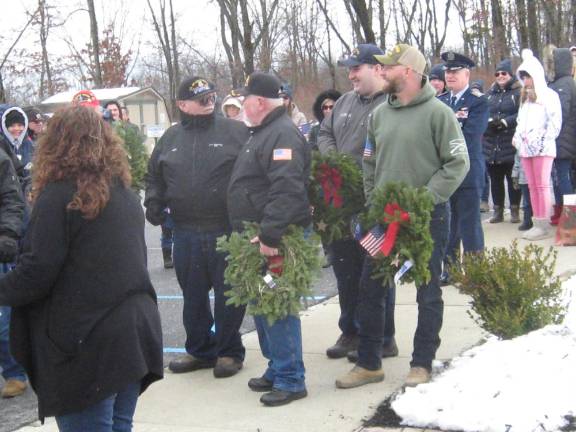 Past and present members of the armed forces wait to present wreaths Saturday in Sparta.