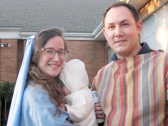 The Vitulli family — Chiara, James and baby James — portray the Holy Family of Mary, Joseph and baby Jesus (Photo by Janet Redyke)