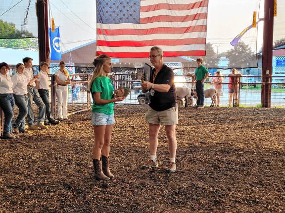 4-H members honored at fair <b>Dave Foord, 4-H senior program coordinator, presents an award to Sophie Stefankiewicz, who won in the plants and horticulture category for her hydrangea.</b>