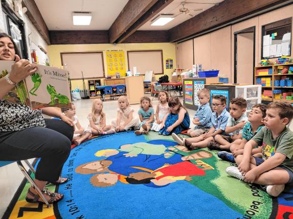 Preschool’s last graduation Pre-kindergarten teacher Christine Palmucci reads to the class.