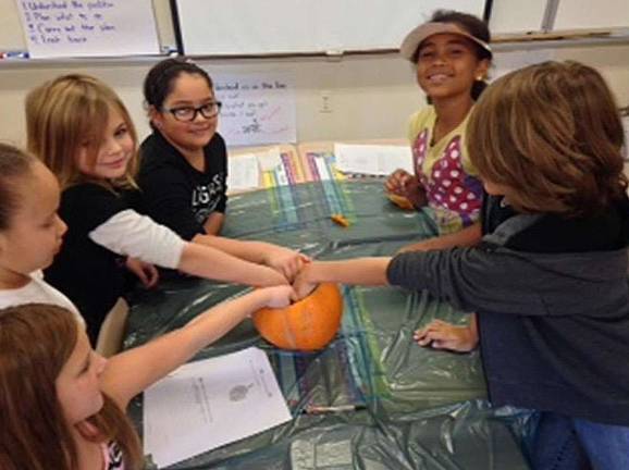 Franklin students experiment with pumpkins Angela Patti, Rebecca Fedder, Mariah Lee, Emma Finamore, Janiesha Dureny, Jackson Moller reach into a pumpkin.