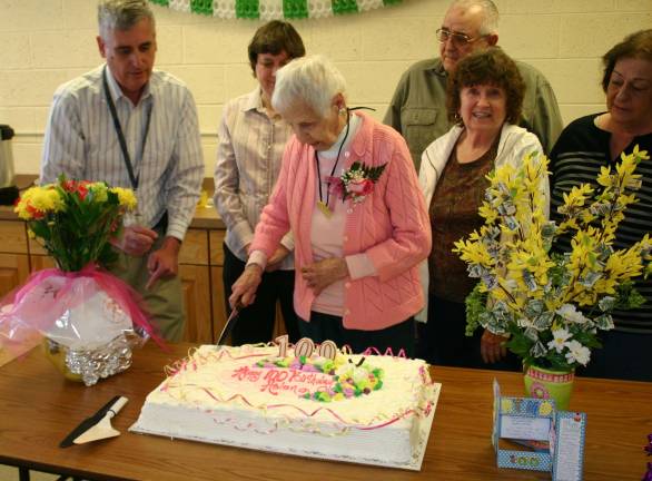 Photo courtesy Ray Hatke Helen Kaposi is shown cutting a cake celebrating her 100th birthdayf at the Senior Citizens of Hardyston Township on Monday, March 9.