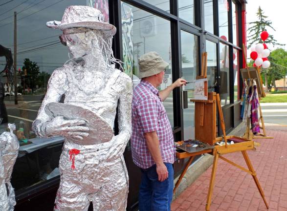 2015: The year in pictures PHOTO BY CHRIS WYMAN A life-sized sculpture by West Milford artist Oscar Beck greeted visitors as they arrived at the Art Etc GalleryþÄôs open house on May16 while Sparta-based painter Tim Maher worked "en plein air" capturing the uniqueness of downtown Hamburg with oil paints.