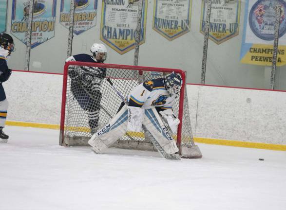 Sparta-Jefferson United goalie Logan Hanek looks at the puck move behind the goal post in the first period. Hanek made 32 saves in the game.
