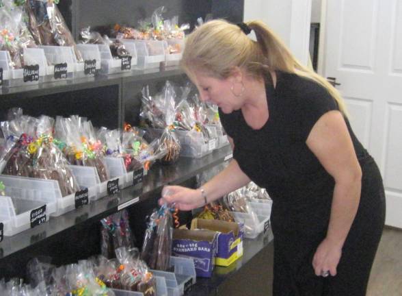 Candy artist Tracey Williams checks the stock of chocolates at her shop Village Sweets.