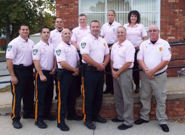 Hamburg police officers sport pink polo shirts to raise breast cancer awareness.