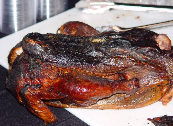 The guest of honor at the Bourbon, BBQ and 9 n Dine was this alligator eating a chicken before being eaten by guests