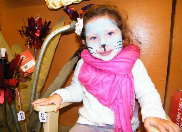 Sofia Hallak, 3, of Wantage models her blue cat-face at the Sussex Christian School's 37th annual harvest festival on Saturday.