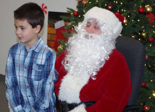 2015: The year in pictures PHOTO BY CHRIS WYMAN John David Frylinck, 8, of Hamburg visits with Santa Claus and his buckets of toys and candy canes at borough hall. SantaþÄôs transportation and related travel considerations were taken care of by Councilman Russ Law.