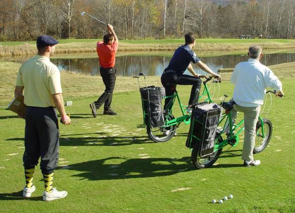 The golf bicycle relay is contested by the team of Mike Bartone, Jim Heron, Steve Gauli and Ricky Hemberger