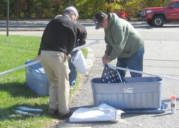 Volunteers set up the flags near Fireman's Pond on Route 515 (Photo by Janet Redyke)