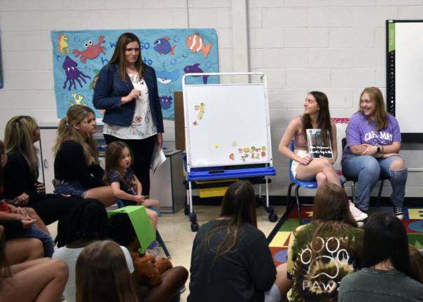 BK5 Jennifer Grabowski, a Wallkill Valley Regional High School English teacher and adviser to the National English Honor Society, speaks to the preschool class. At right are seniors Nicole DeFinis and Charlotte Gough.