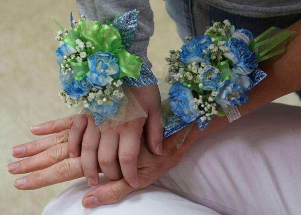 Melissa Wood and Maya Gordon wear blue flower wrist bouquets in honor of Histiocytosis month in September.