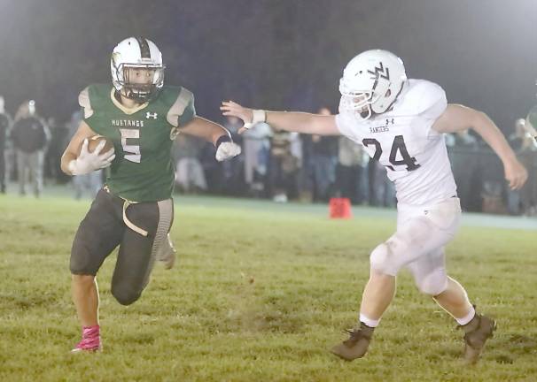 Sussex Tech ball carrier Bo Maroney avoids the reach of Wallkill Valley defensive lineman Kevin Armstrong in the second half. Maroney rushed for two touchdowns.