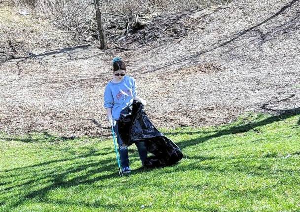 Girl Scout Catherine Byra tidies the park.