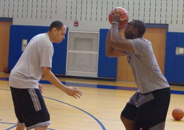 From left Sussex County Community College head basketball coach Randy Jackson assists Crossroads founder and Blair Academy assistant basketball coach Cornell Thomas in a technique demonstration.