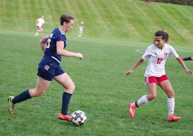 Vernon's Elise Kastner dribbles the ball as High Point's Ela Christensen closes in during the second period.