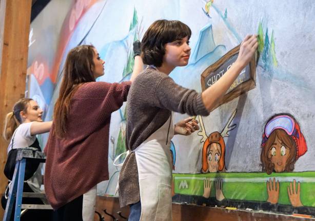 Sussex Tech students paint Mountain Creek mural From left, students Sarah Biccum, Nikki Swiderski, and Cailey Pokrzywa create a new chalk mural in Schuss Bar.