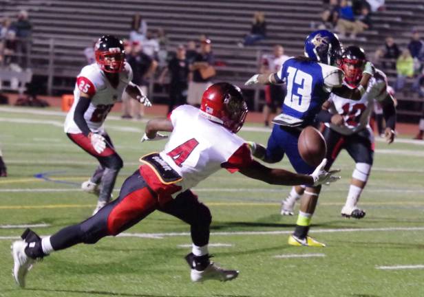 Watertown defender RaKwan Allen reaches for the ball in an interception attempt after it is overthrown by the Sussex quarterback.