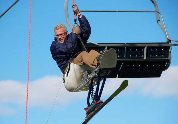 Chuck Wallace, Advisory Committee member demonstrates proper adaptive skier evacuation from a chair lift.