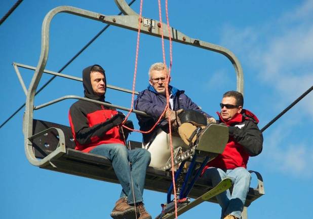 Chuck Wallace is assisted by Mountain Creek Ski Patrollers in proper chair lift evacuation procedure.