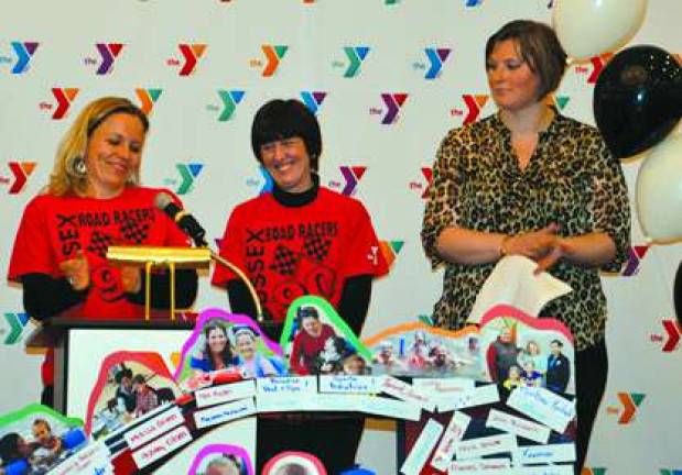 During the 2014 YMCA Annual Campaign Celebration Sussex County YMCA Member Executive Director Jennifer Gardner announces Sussex County YMCA exceeded their goal of $205,000. Jennifer Gardner,executive director, campaign chairperson Lisa Pompey Smith and Allie Andersen Y member.