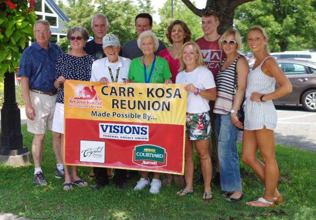 The Kosa and Carr families pause for a group photograph following the presentation.
